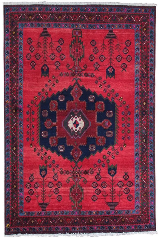 Red-and-blue oriental rug with a central medallion and geometric vine pattern, rectangular.