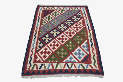 Colorful kilim with a geometric diamond pattern and dark border, with fringes