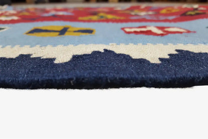 Close-up of the kilim edge with a blue border and multicolored patterns