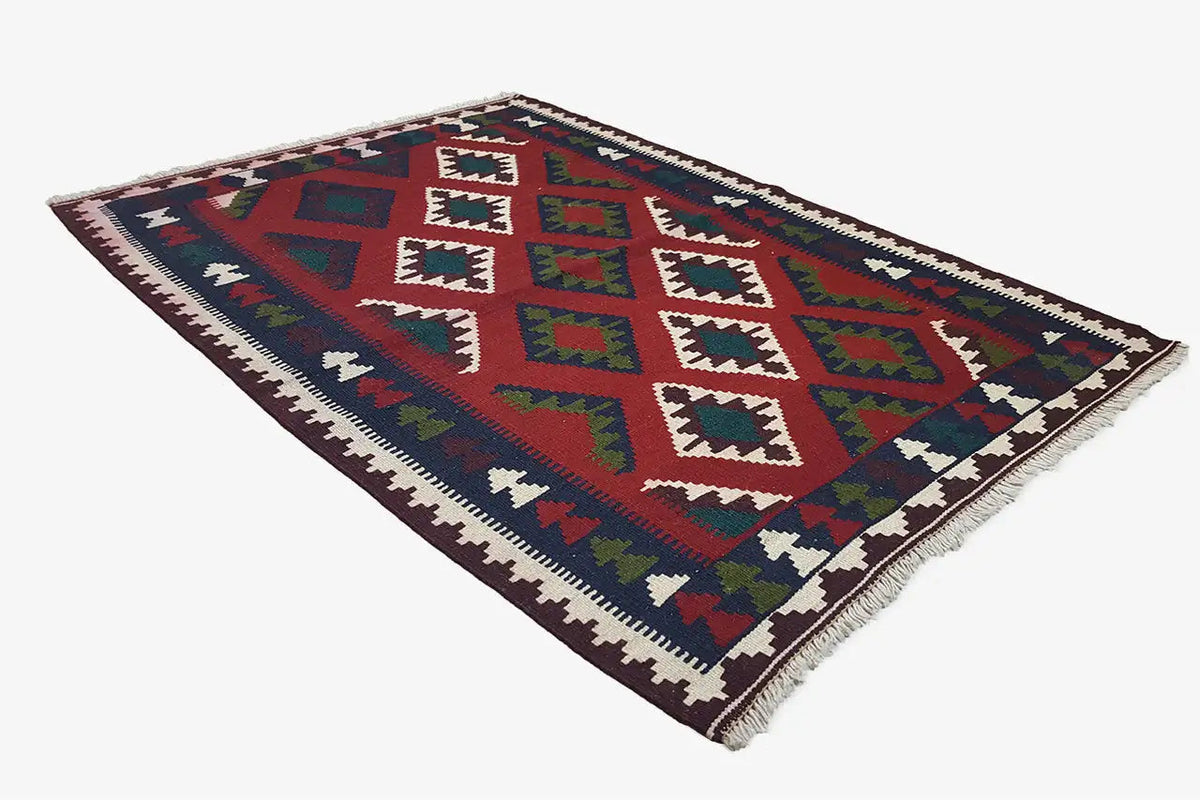 Kilim Qashqai rug, diagonally rotated, with geometric shapes in red, blue, green, and cream