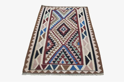 Kilim rug with a central diamond motif and multicolored border trim