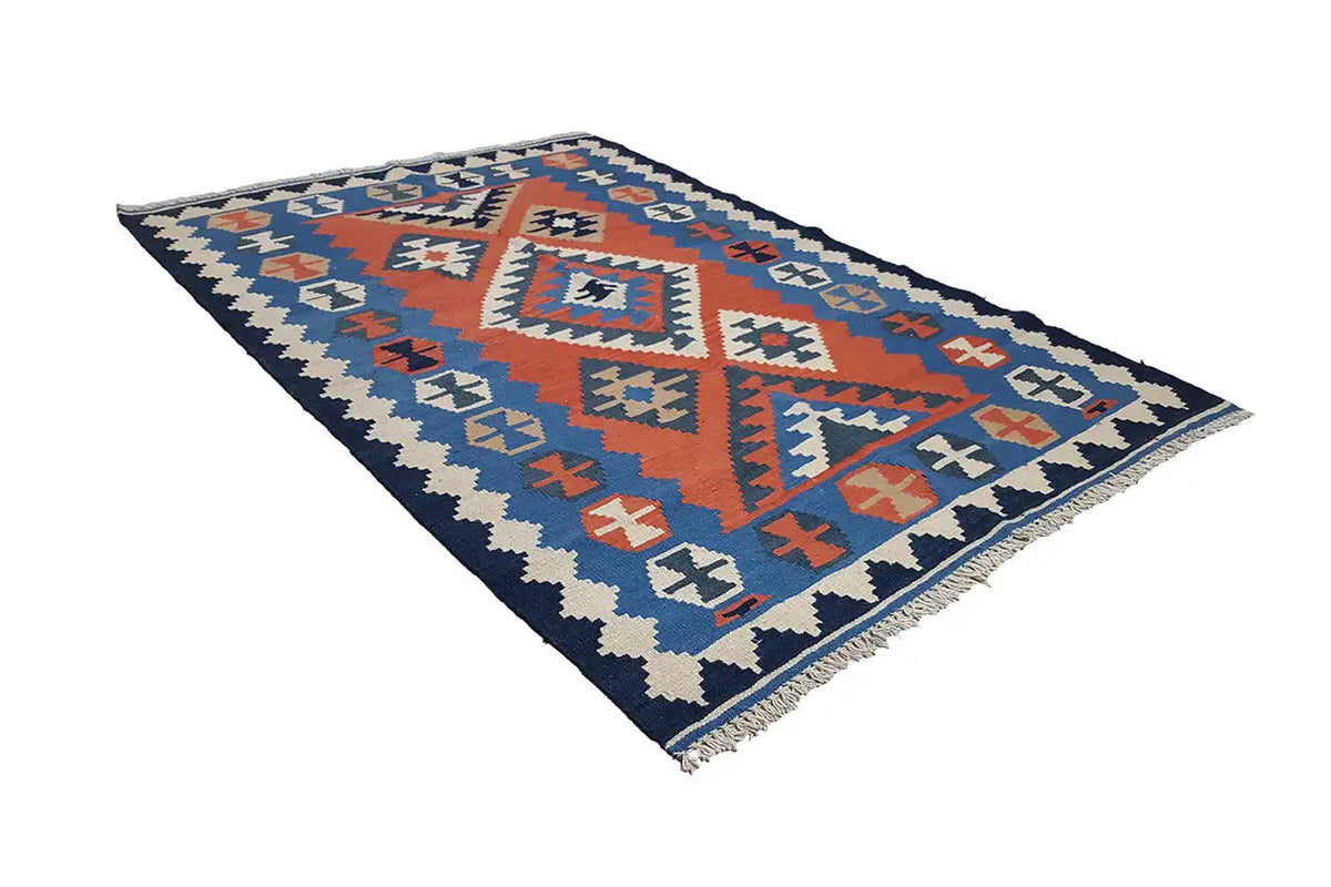 Kilim rug with geometric panels in blue and red, zigzag pattern along the edges