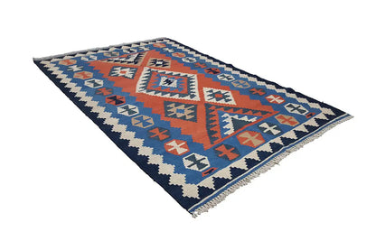 Kilim rug with geometric panels in blue and red, zigzag pattern along the edges