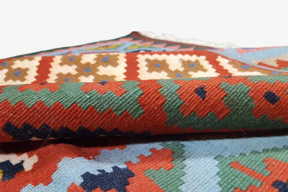 Close-up of the kilim border with colorful zigzag and wave patterns, woven texture