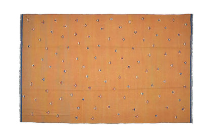 Rectangular Oriental rug, warm brown-orange with small colorful patterns and a dark border.