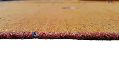 Detail on the carpet edge: dark red selvedge with a blue hemline.