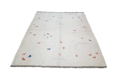 Light beige kilim rug with a small pattern of red and blue figures, frayed edges