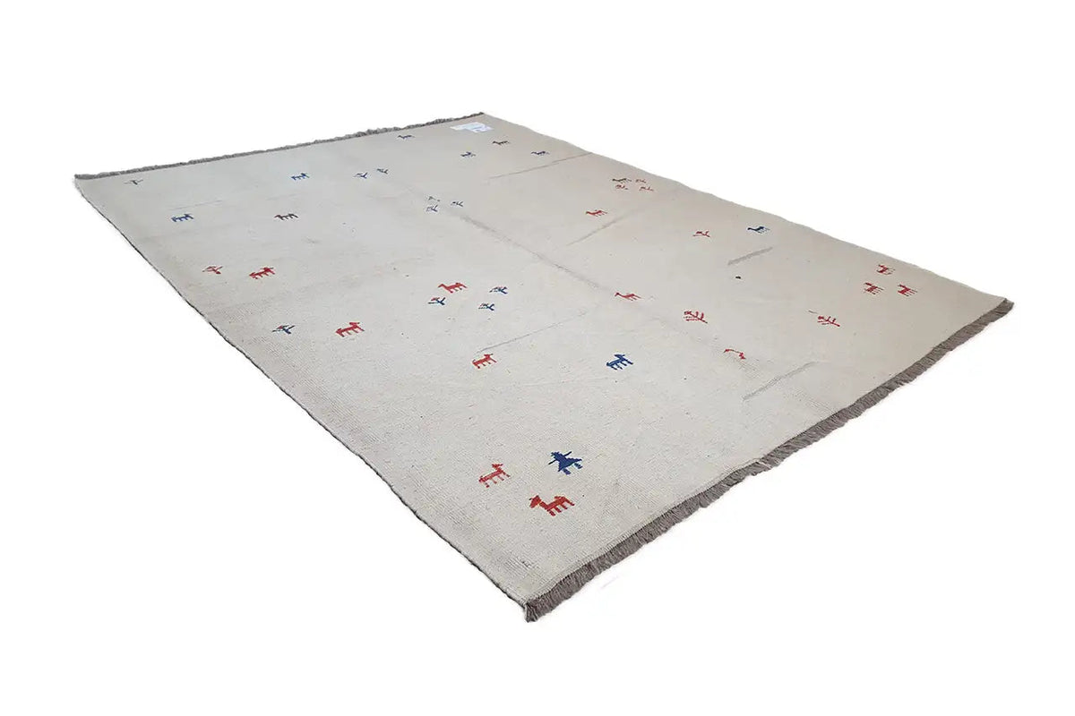 Kilim rug in light beige with a scattered pattern of red and blue animal figures, laid flat