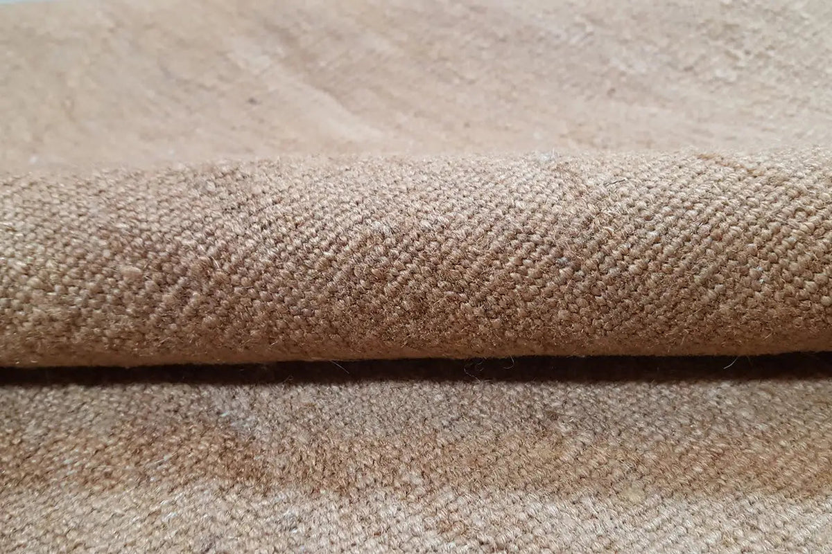 Close-up: Kilim fabric with a dense, beige texture and fine surface structure