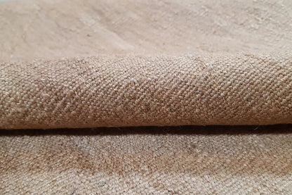 Close-up: Kilim fabric with a dense, beige texture and fine surface structure