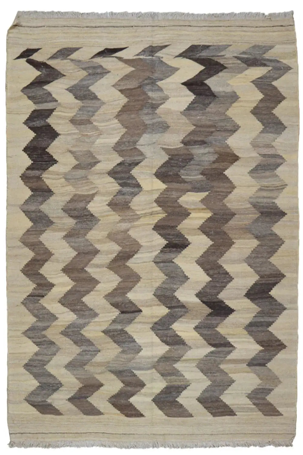 Kilim rug with a zigzag pattern, light beige background, taupe chevrons, and fringes.
