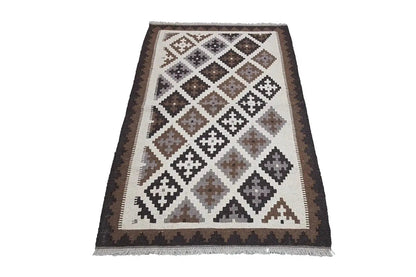 Kilim rug with a geometric diamond pattern in beige, brown, and dark gray