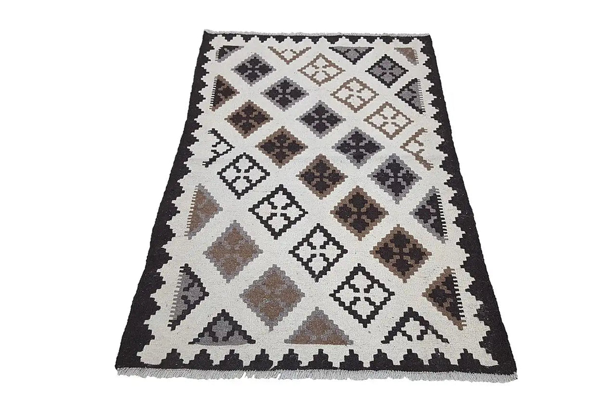 Kilim rug with a geometric pattern in cream, black, and brown tones