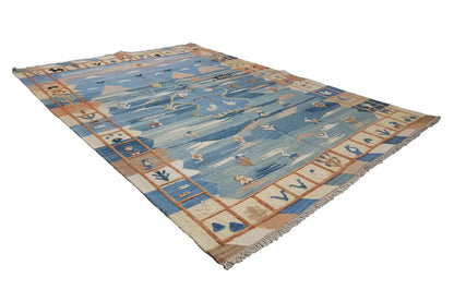 Kilim rug with a blue base, geometric rows, and fringes along the edges