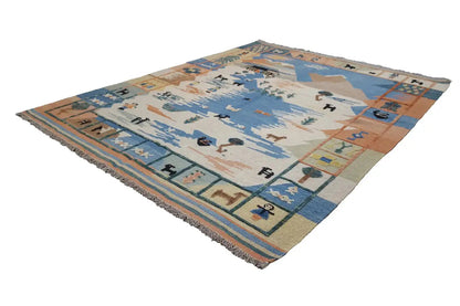 Kilim rug with a geometric pattern in blue, beige, and orange, with fringes at the corners