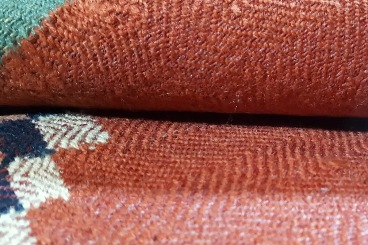 Detailed view: Jajim rug with a reddish-brown, woven pile and fine texture