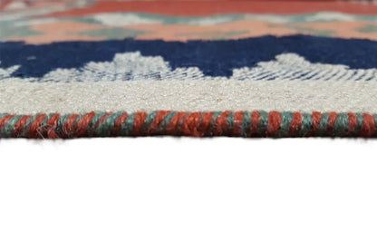 Rug edge with patterned bands and fringe; central area partly dark blue and gray