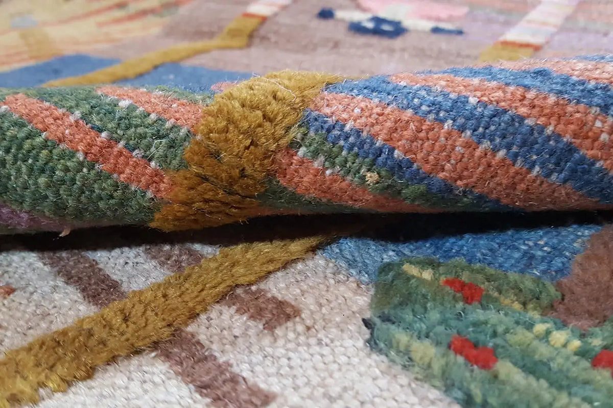 Woven kilim with a dense texture, multicolored stripes, and fringes
