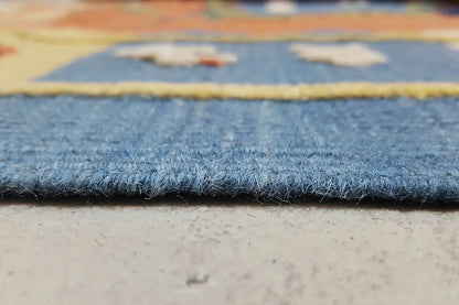 Rug edge with dense pile and dark blue fringe border