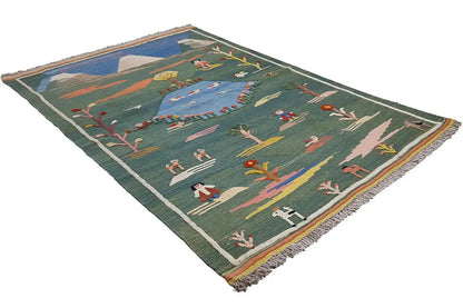 Green kilim rug with landscape motifs, diagonal view, fringed border all around