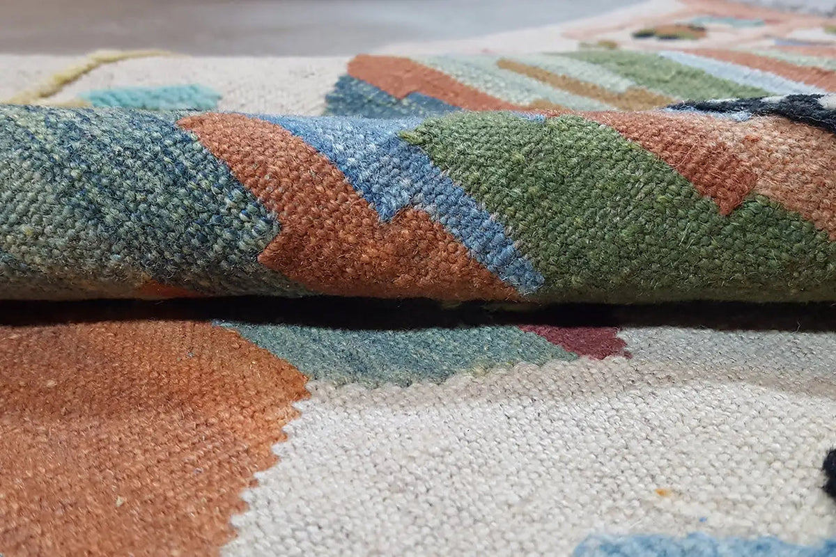 Close-up of carpet surface: multicolored wool pile with distinct patterned sections