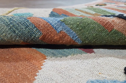Close-up of carpet surface: multicolored wool pile with distinct patterned sections