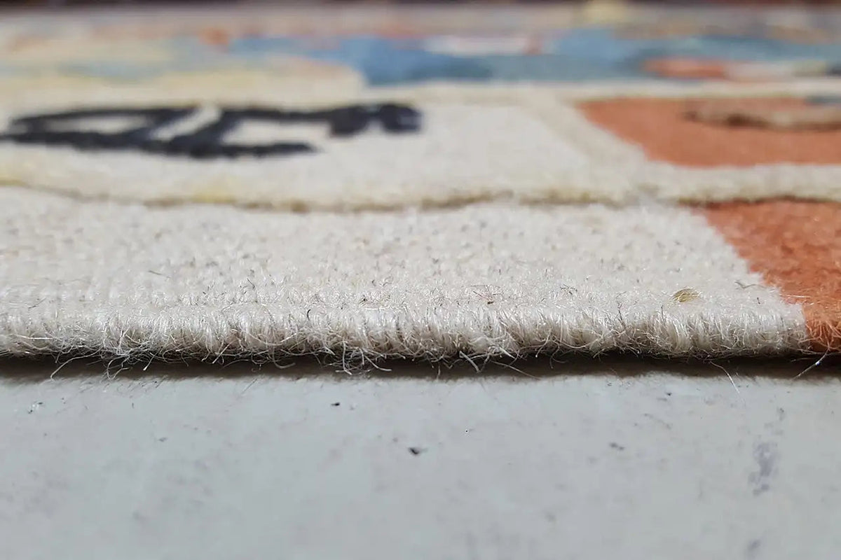 Close-up of the edge: off-white beige kilim with short fringes and a woven texture