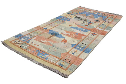 Oriental rug with a geometric animal and symbol pattern in beige, blue, and red