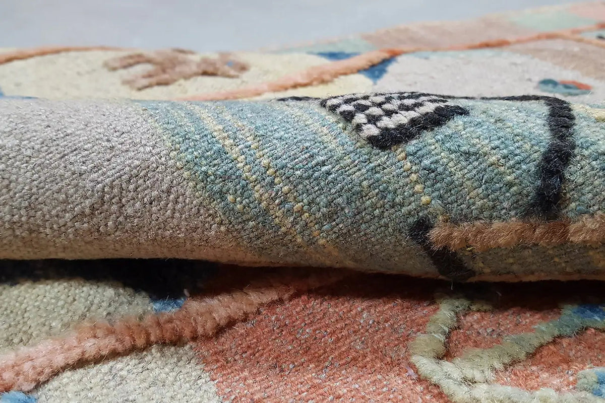 Close-up: pattern of the Oriental rug with a blue-brown design and dense weave structure