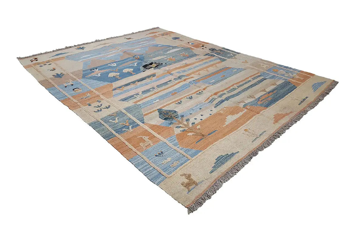 Kilim rug positioned diagonally, blue and beige areas with figurative motifs, fringes.