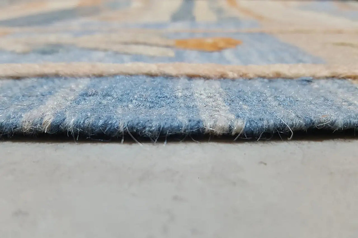 Kilim edge in detail with fringe and blue, beige pile.