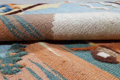Kilim rug detail: woven texture with multicolored ornamental stripes.