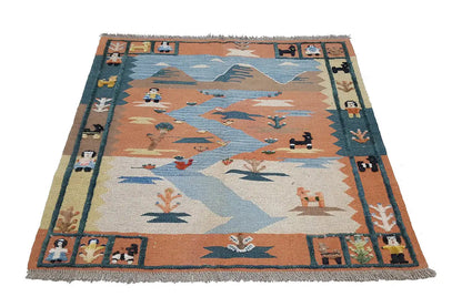 Kilim rug with multicolored patterns in blue, brown, and beige, as well as decorative fringes