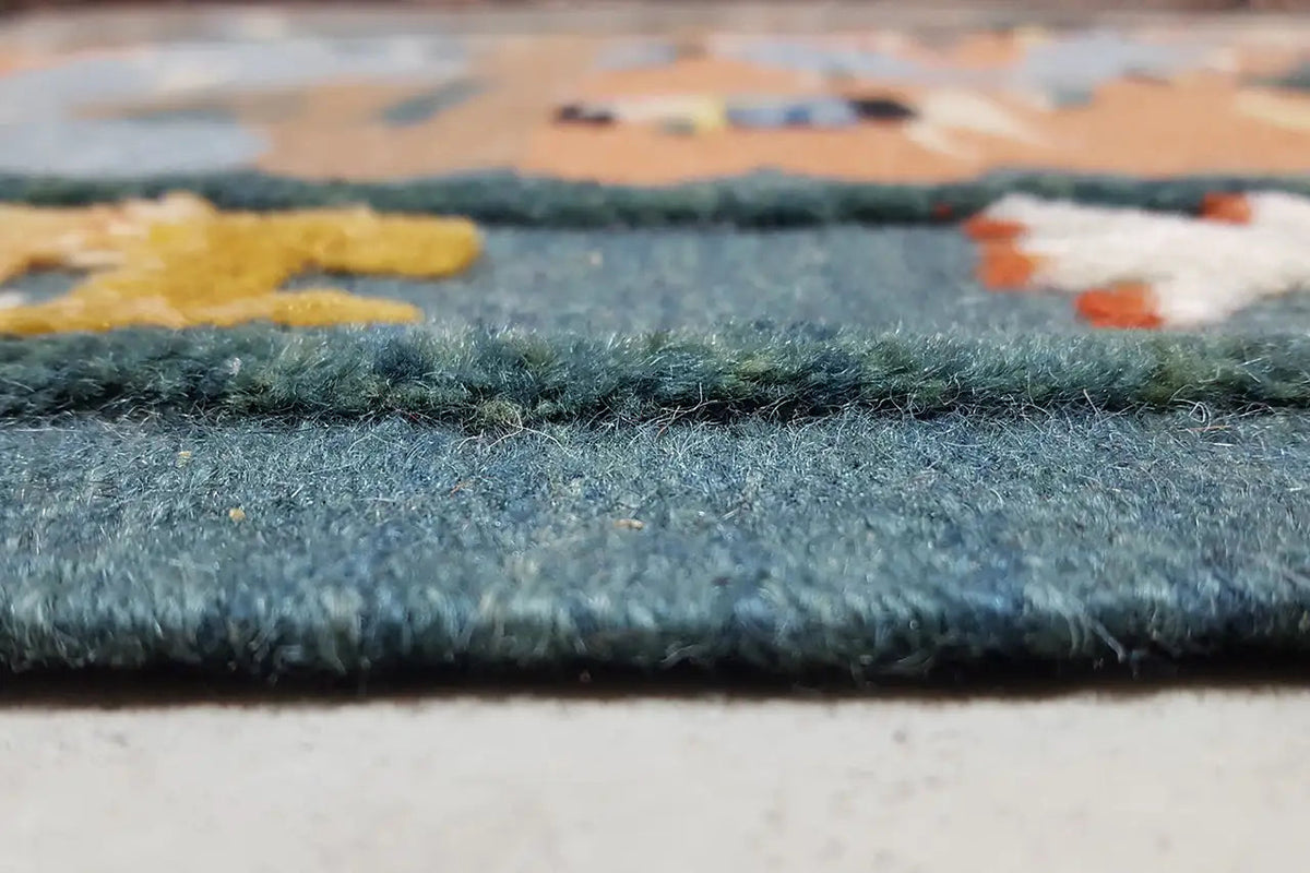 Close-up of the rug edge with a short, dense pile in blue and beige