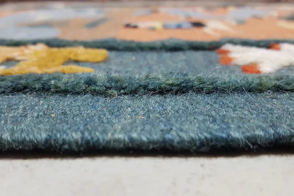 Close-up of the rug edge with a short, dense pile in blue and beige