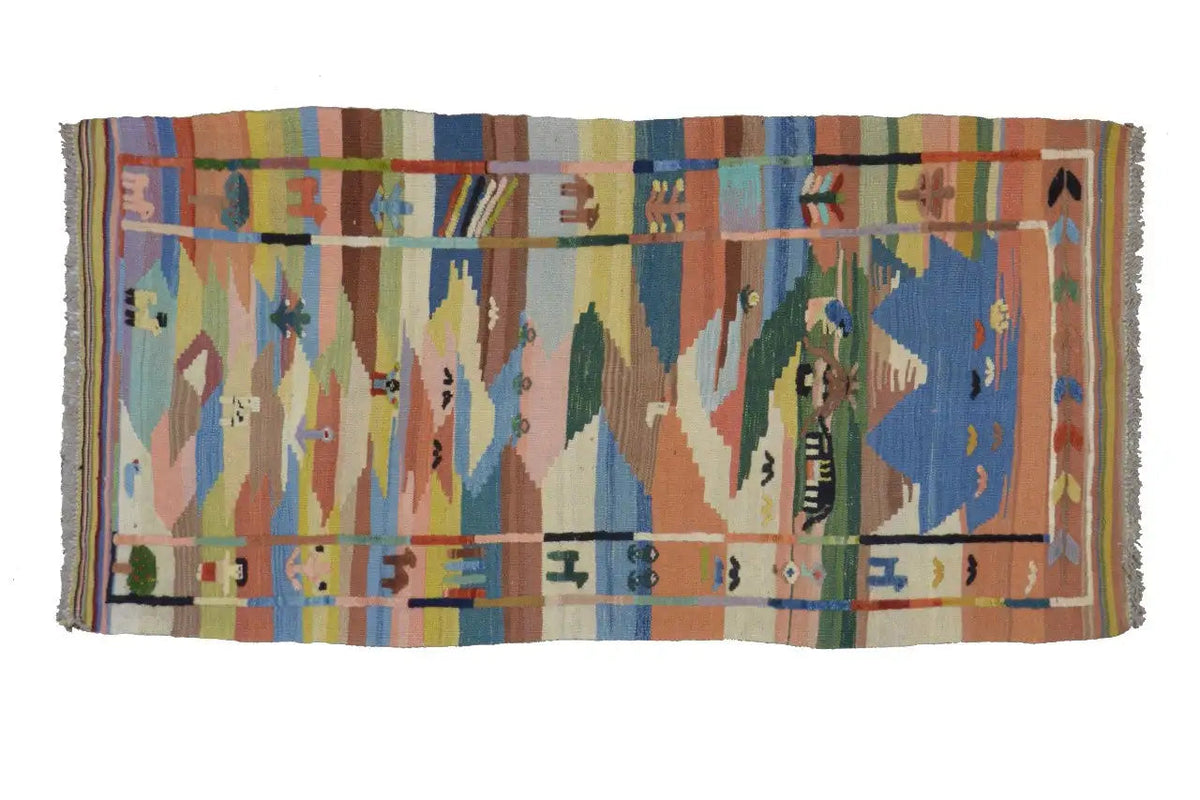 Oriental rug with a geometric border pattern in blue, orange, green, and beige, with fringes