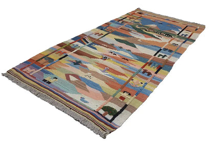 Flatweave rug with a patchwork-like linear pattern in blue, beige and rust red, fringes