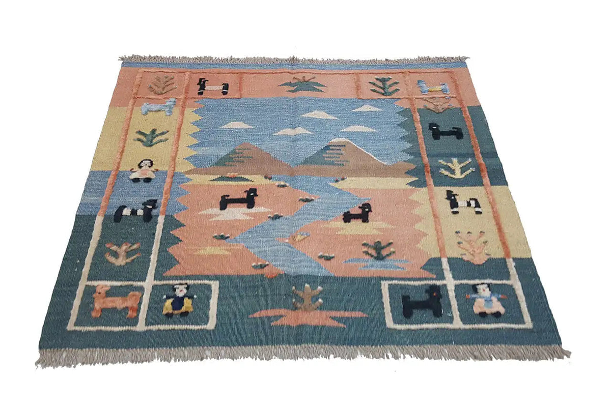 Kilim rug with a geometric pattern in blue, brown, and cream, with fringes