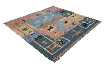 Geometric-patterned carpet in brown, blue, and cream, with a decorative border