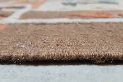 Close-up of the carpet edge with dense pile and a rough, brown woven texture