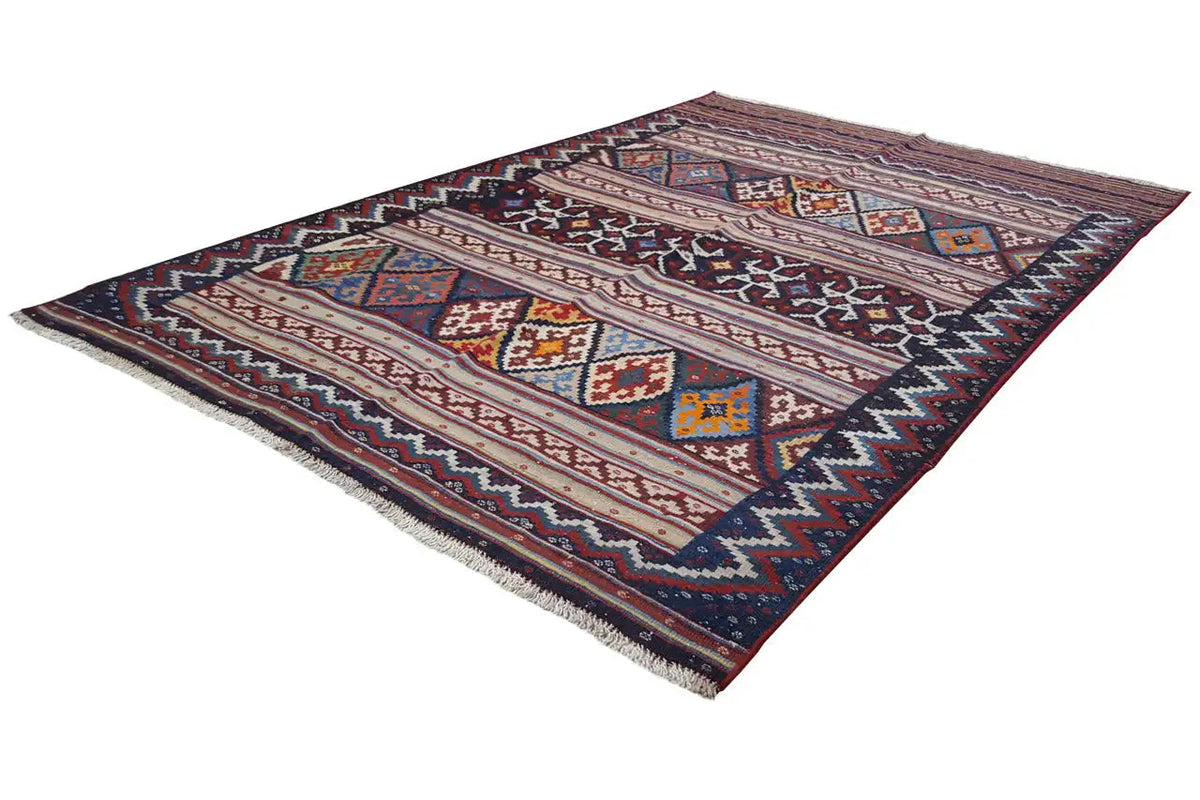 Kilim rug lying at an angle with geometric fields and a zigzag border