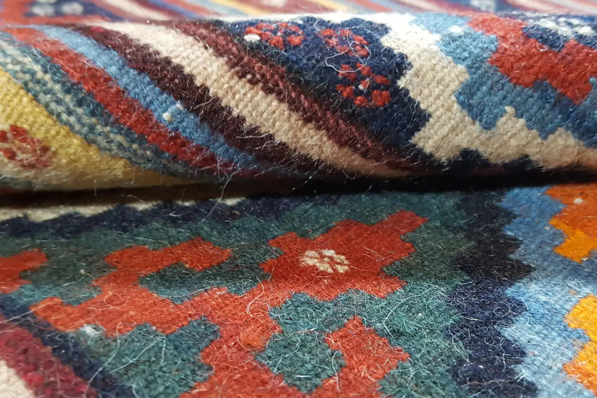 Close-up of the kilim weave with colorful ornaments and visible wool fiber texture