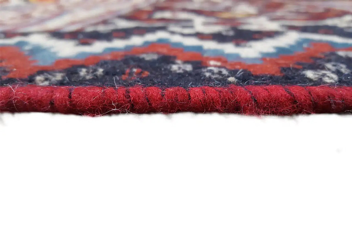 Kilim rug view of the edge with red fringes and a thick selvedge