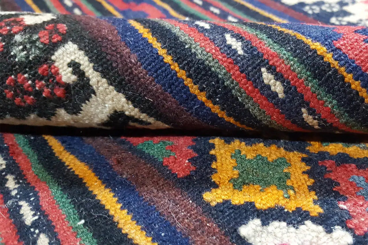 Textile surface of the kilim rug with colorful diamond and stripe patterns