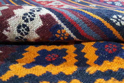 Kilim rug detail: white pattern dots, dark red areas, and yellow motifs