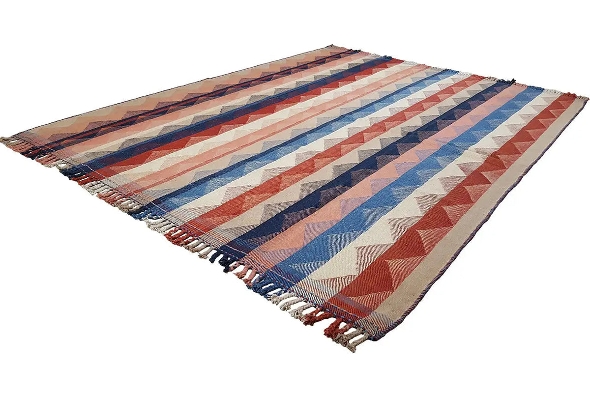 Rectangular Jajim rug with zigzag stripes in blue, red, and beige, shown with fringes.