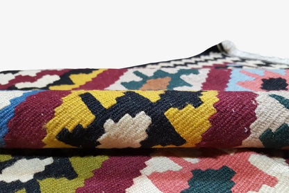 Kilim rug close-up: woven color blocks with a diamond pattern and short pile