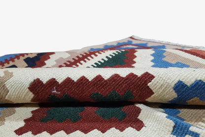 Kelim rug detail: multicolored ornaments and woven-textured edges