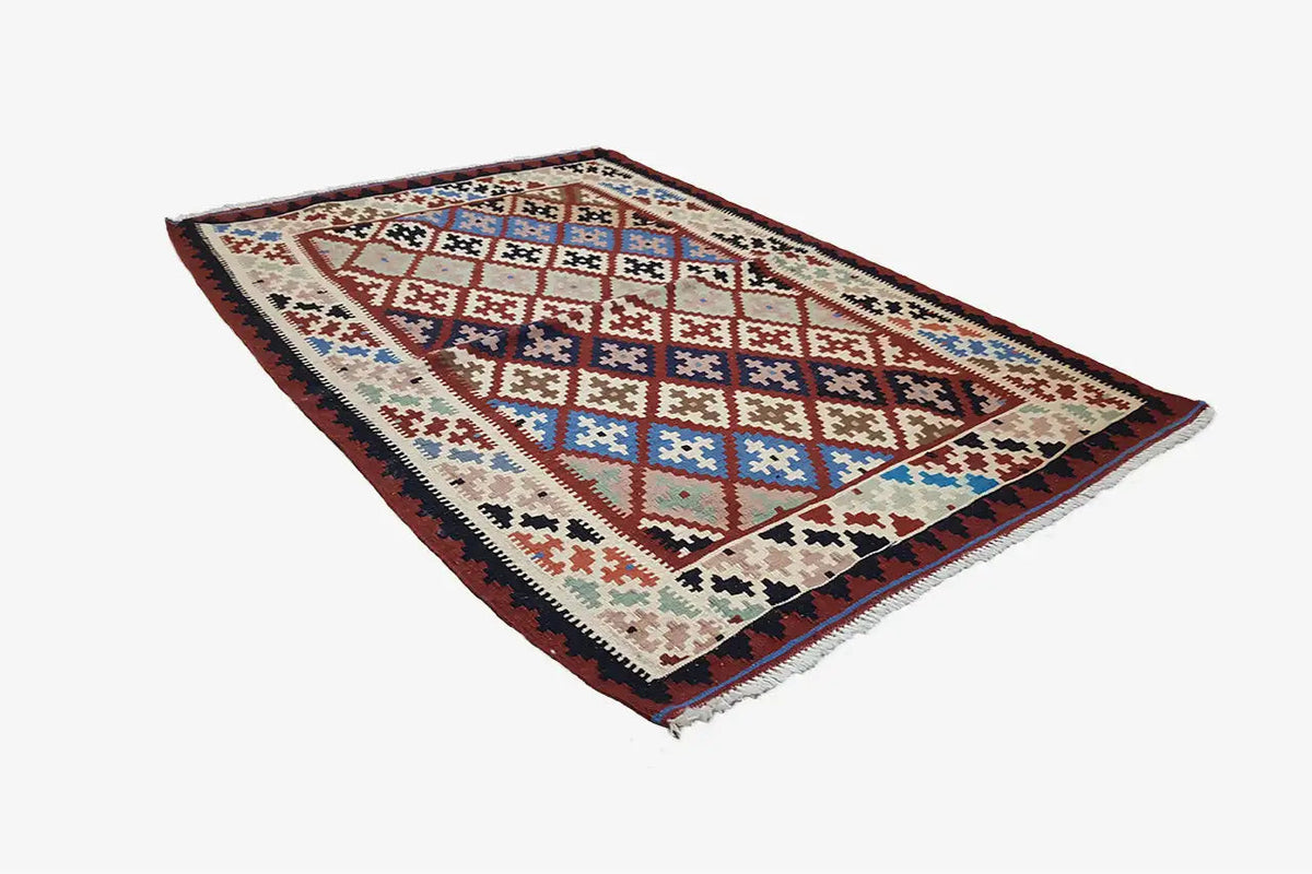 Kilim rug with diagonal diamonds and block patterns in red, blue, and cream