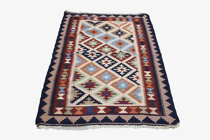 Multicolor kilim with geometric patterns and a dark bordered edge